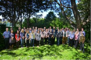 Group photo of MERP scientists in the PML garden surrounded by trees